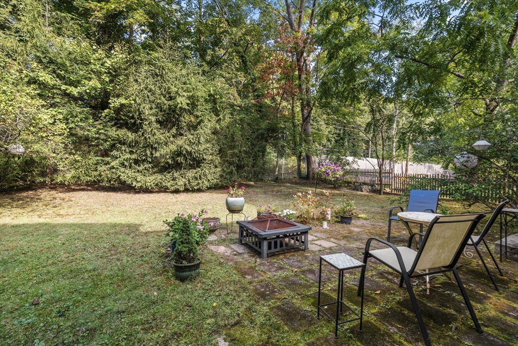 174 Middlesex Road Chestnut Hill, MA 02467 - Photo 17 of 18 a backyard of a house with table and chairs