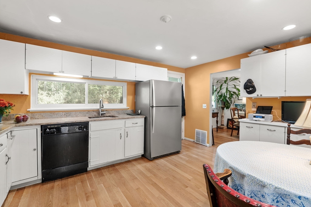 174 Middlesex Road Chestnut Hill, MA 02467 - Photo 6 of 18 a kitchen with a refrigerator and a stove top oven