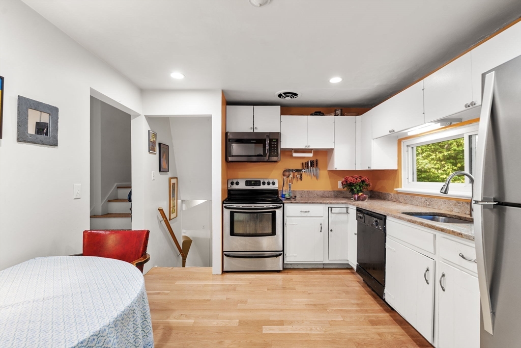 174 Middlesex Road Chestnut Hill, MA 02467 - Photo 7 of 18 a kitchen with stainless steel appliances kitchen island granite countertop a refrigerator and a stove top oven