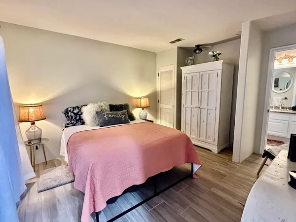 a bedroom with a bed and wooden floor