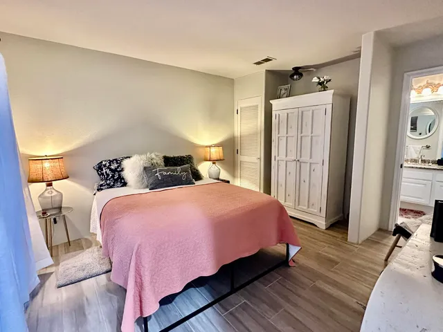 a bedroom with a bed and wooden floor