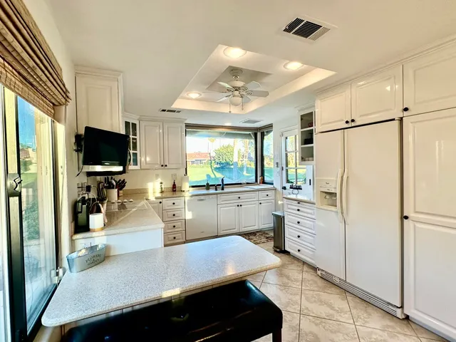 a kitchen with refrigerator and window