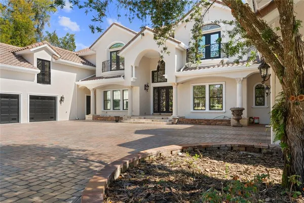 a view of a house with backyard and sitting area