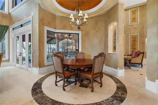 a living room with furniture a chandelier and a flat screen tv
