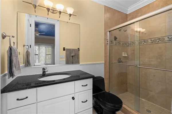a bathroom with a shower and a sink