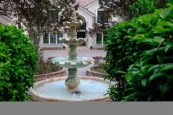 a living room with furniture a window and a chandelier