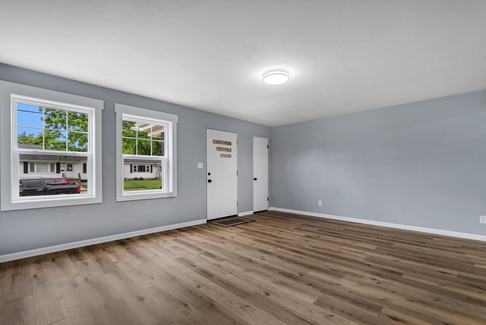 1314 West Washington Street Ottawa, IL 61350 - Photo 4 of 21 a view of an empty room with wooden floor and a window