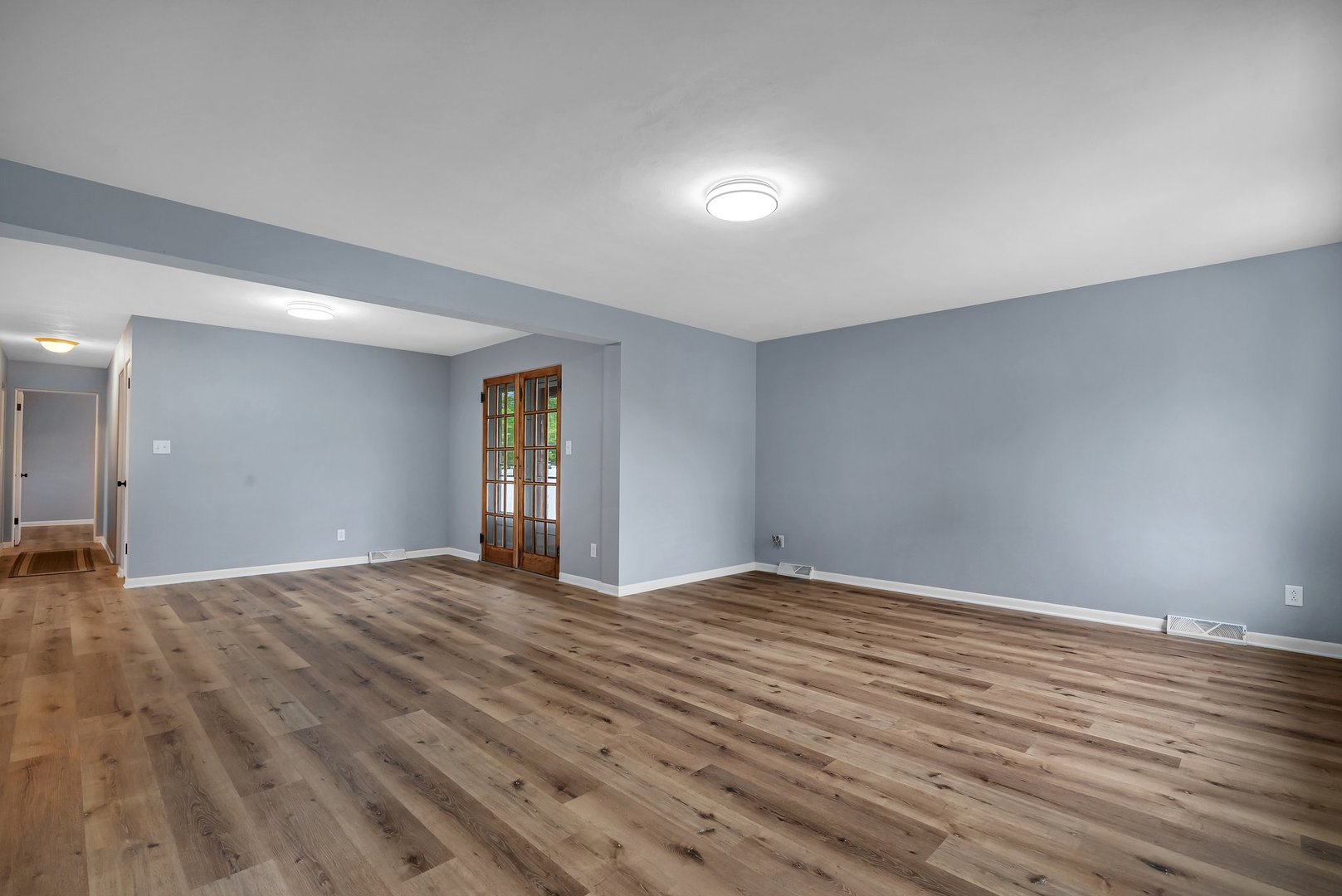 1314 West Washington Street Ottawa, IL 61350 - Photo 5 of 21 a view of an empty room with wooden floor and a window
