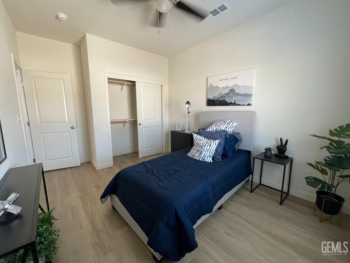 Undisclosed Address Bakersfield, CA 93314 - Photo 9 of 12 a bedroom with a bed and wooden floor