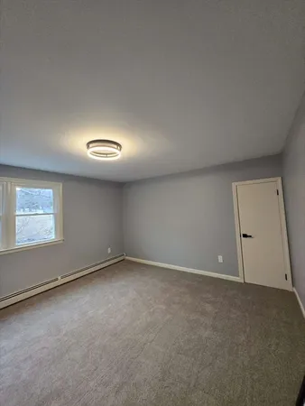 an empty room with a empty space and windows
