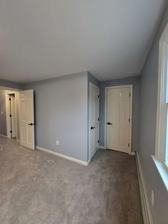 a view of an empty room and closet area