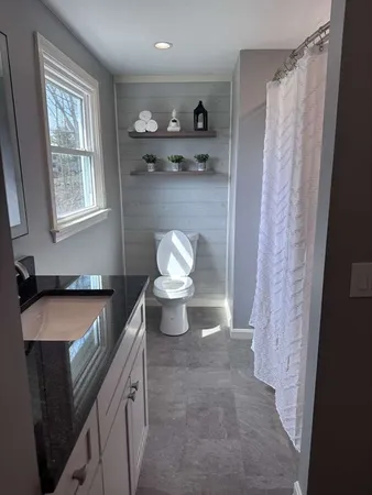 a kitchen with a sink and a toilet
