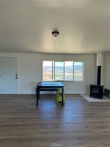 a view of room with furniture and wooden floor