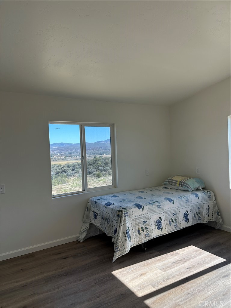 39035 Indian Road Anza, CA 92539 - Photo 5 of 8 a bedroom with a bed and a window