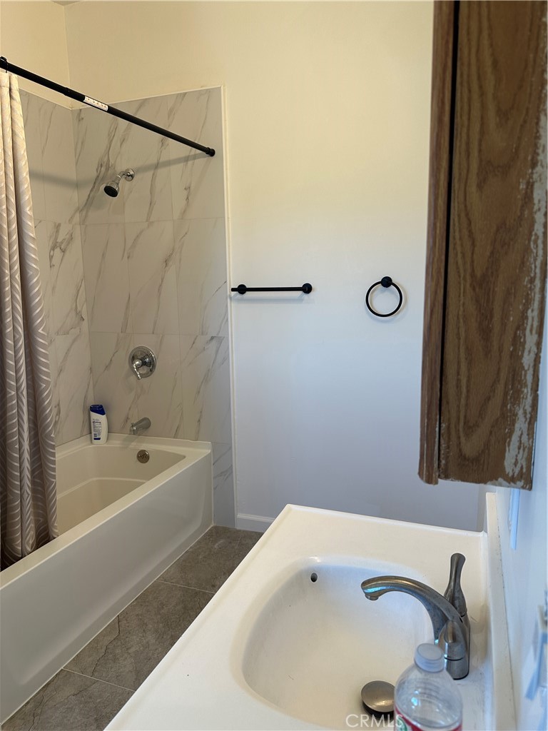 39035 Indian Road Anza, CA 92539 - Photo 7 of 8 a bathroom with a tub a sink and a shower curtain