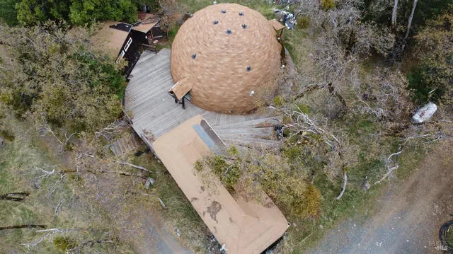 an aerial view of a house with a yard