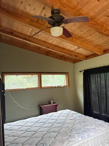 a bedroom with a bed and a window