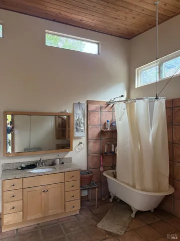 a bathroom with a double vanity sink toilet and mirror