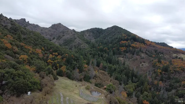 an aerial view of a house with a yard basket ball court