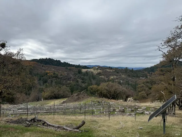 an aerial view of a house with a yard and balcony