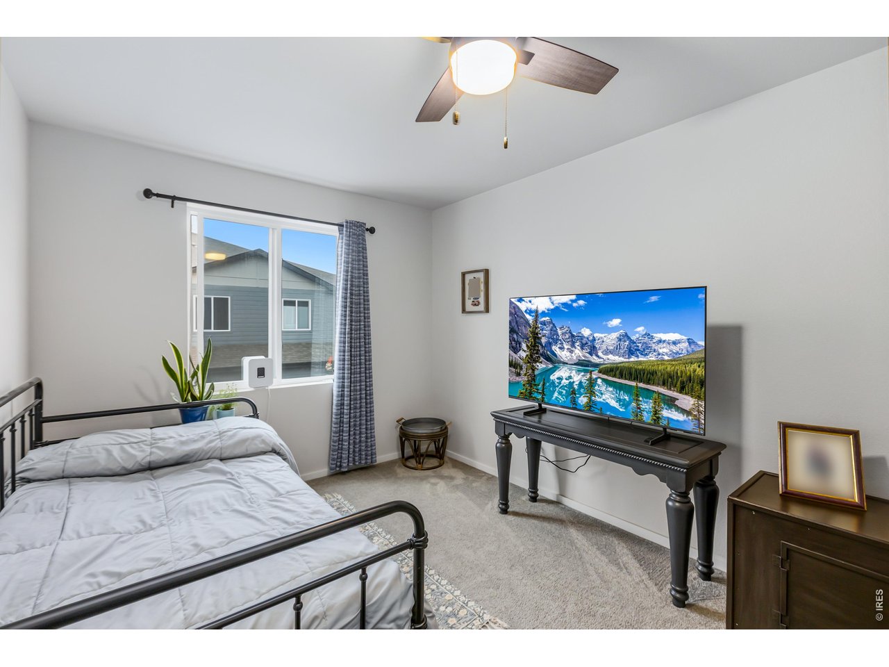 6609 4th St Road, Unit 4 Greeley, CO 80634 - Photo 31 of 41 a living room with furniture and a flat screen tv
