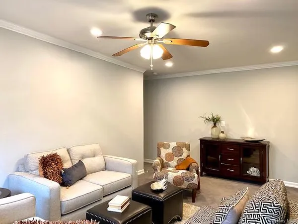 a living room with furniture and a chandelier
