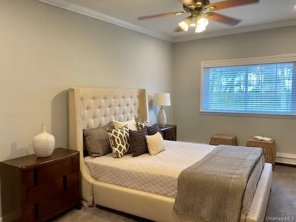 a bedroom with a bed and window