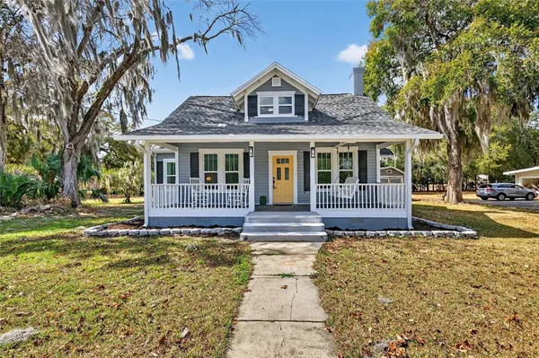 a view of a house with a fountain in a yard