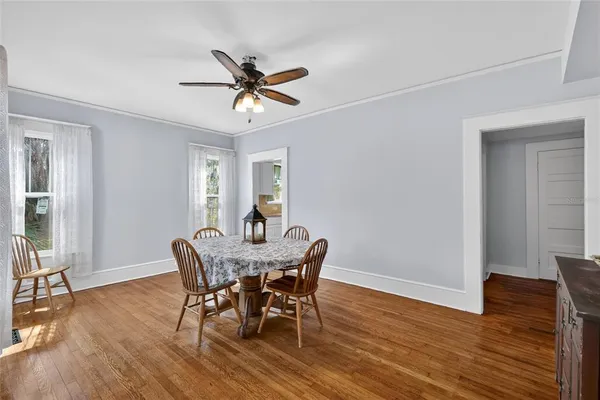 a view of a dining room with furniture and wooden floor