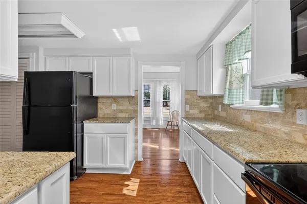 a kitchen with a refrigerator and a sink