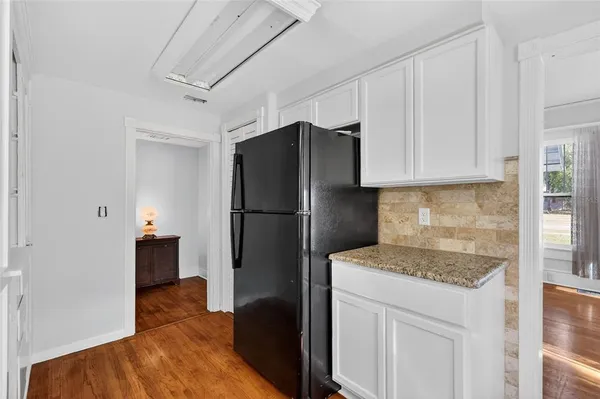 a kitchen with a refrigerator and a stove top oven