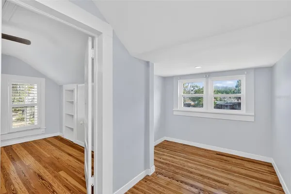 a view of a room with wooden floor and window