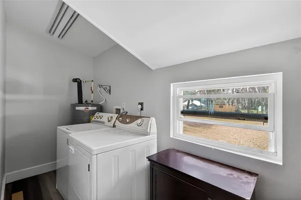 a view of bathroom with baby crib and wooden floor