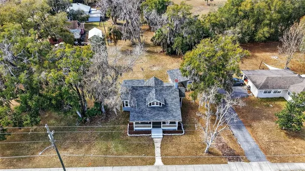 an aerial view of a house with garden space and lake view