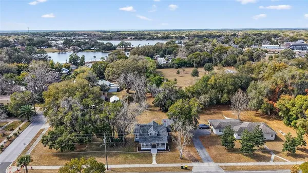 an aerial view of residential houses with outdoor space and swimming pool