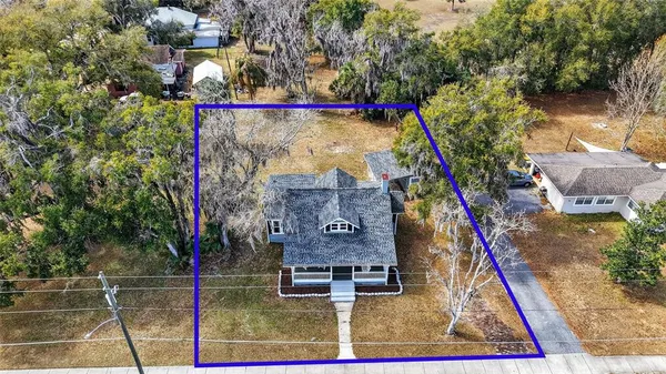 an aerial view of a house with a yard