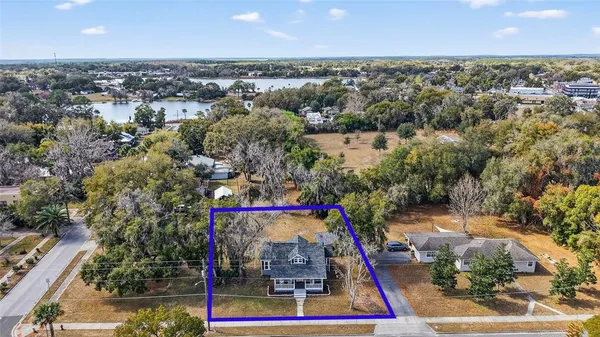 an aerial view of residential houses with outdoor space and swimming pool