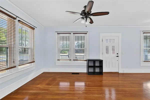 a view of livingroom with hardwood floor and a ceiling fan