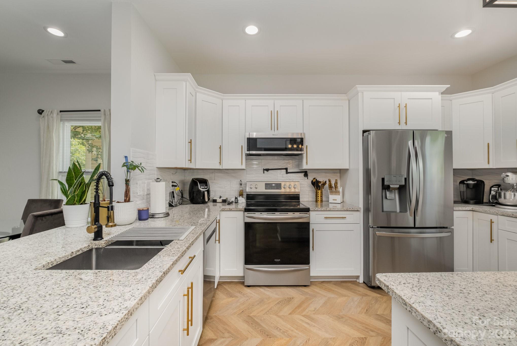 2213 Turtle Point Road Charlotte, NC 28262 - Photo 11 of 28 a kitchen with a sink refrigerator and microwave
