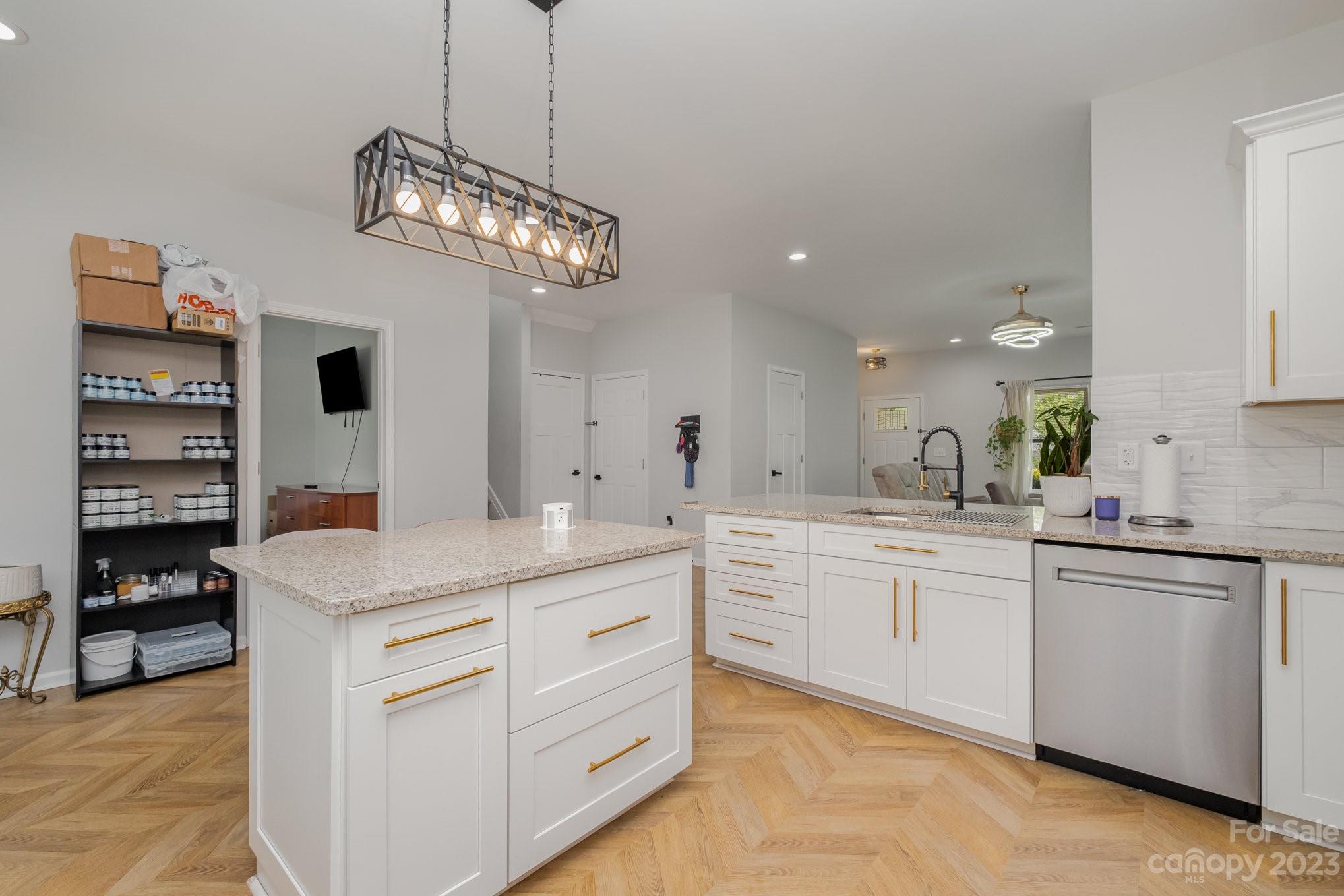 2213 Turtle Point Road Charlotte, NC 28262 - Photo 12 of 28 a kitchen with a sink and dishwasher with white cabinets