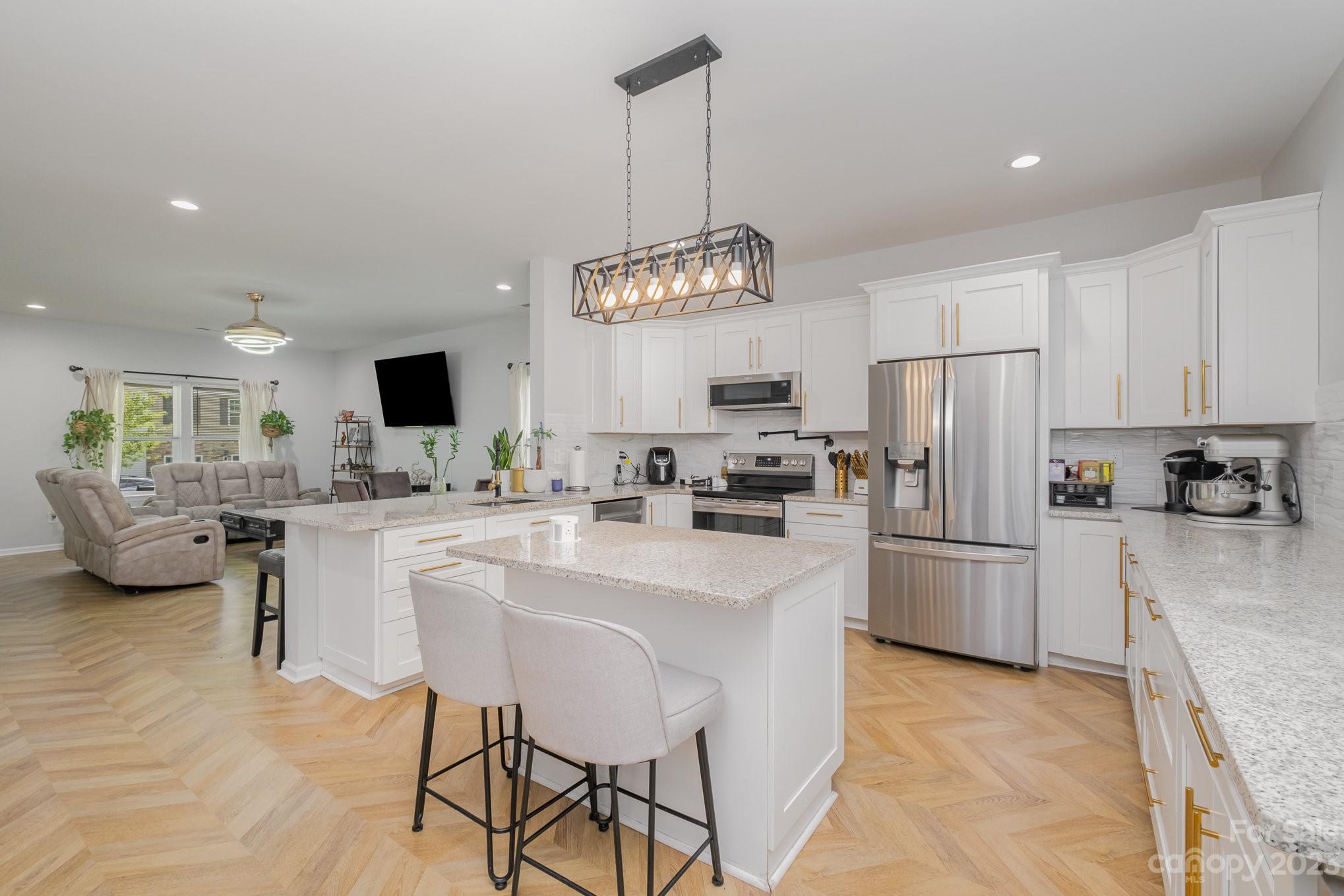 2213 Turtle Point Road Charlotte, NC 28262 - Photo 13 of 28 a kitchen with refrigerator cabinets and a center island