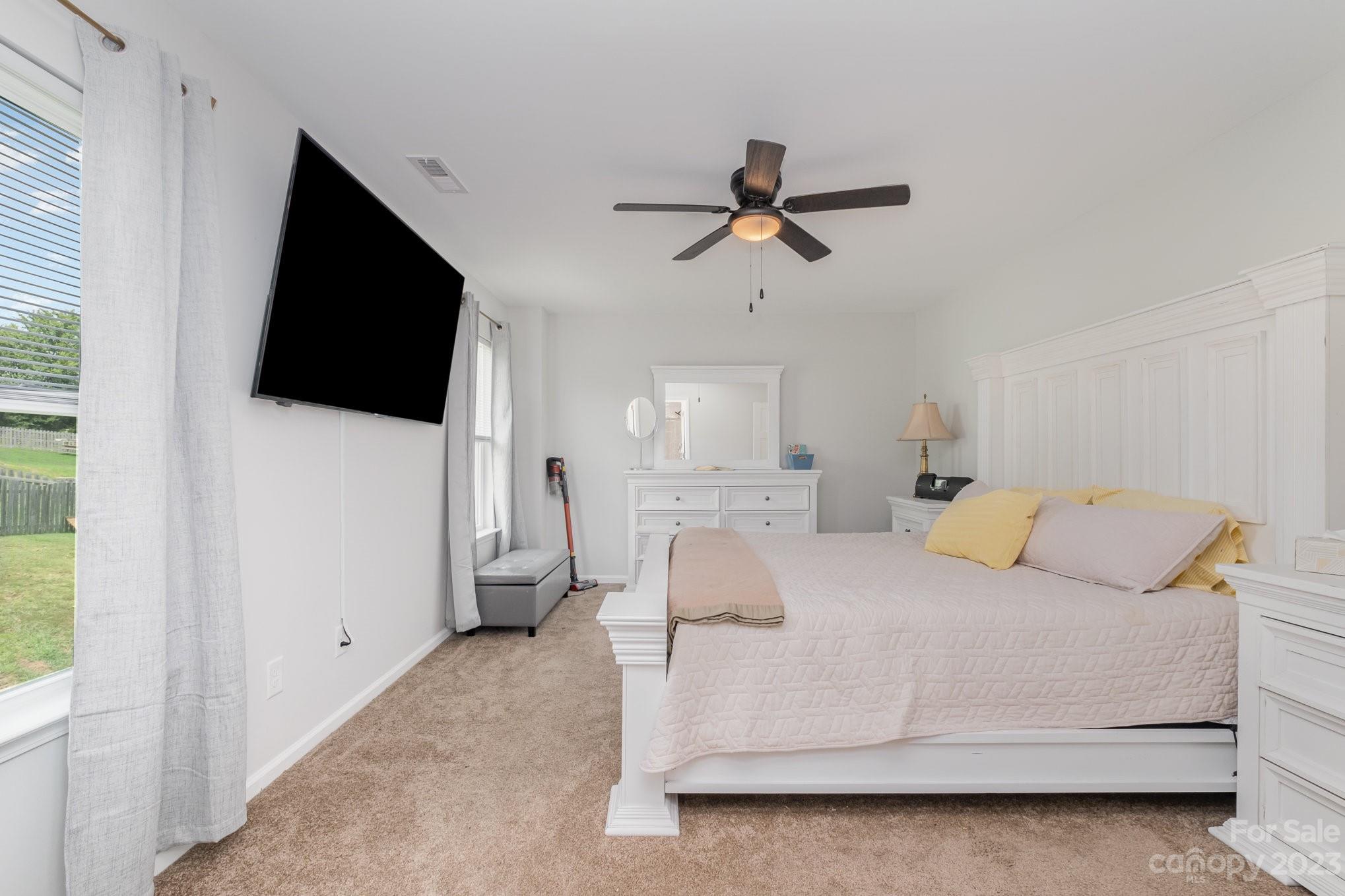2213 Turtle Point Road Charlotte, NC 28262 - Photo 17 of 28 a living room with a bed furniture and a flat screen tv