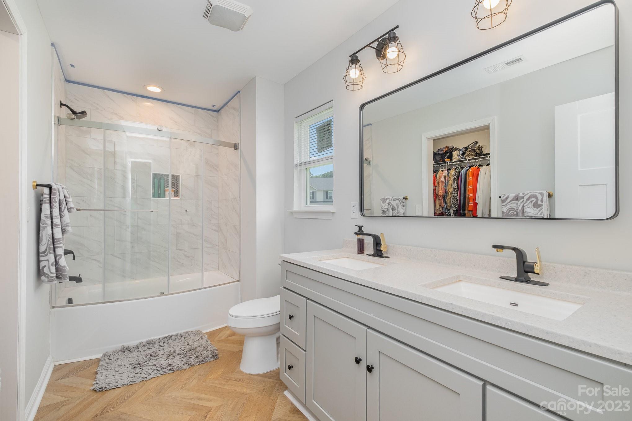 2213 Turtle Point Road Charlotte, NC 28262 - Photo 19 of 28 a bathroom with a sink a toilet and shower