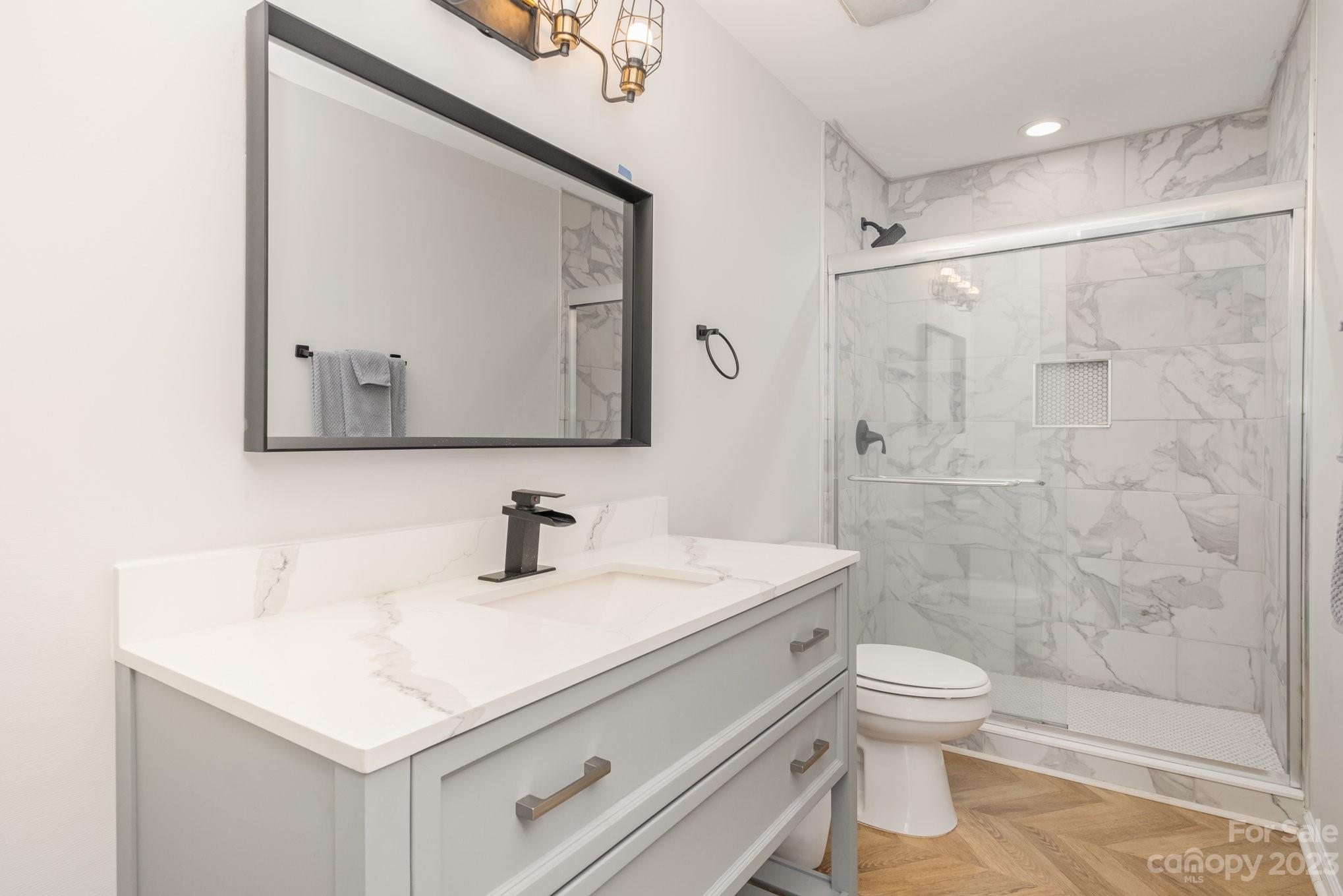 2213 Turtle Point Road Charlotte, NC 28262 - Photo 21 of 28 a bathroom with a sink toilet and shower