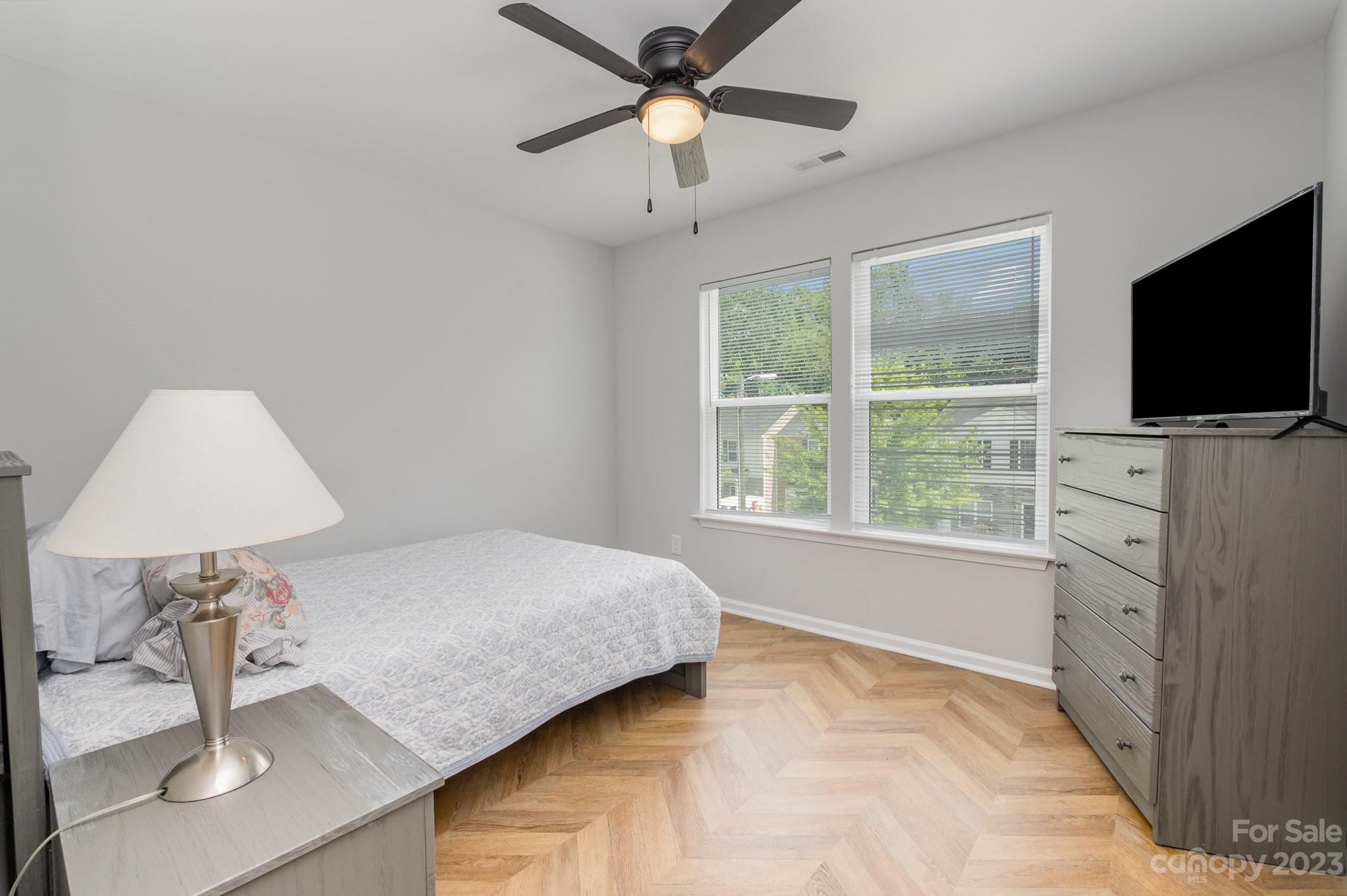 2213 Turtle Point Road Charlotte, NC 28262 - Photo 23 of 28 a bedroom with a bed and a flat screen tv