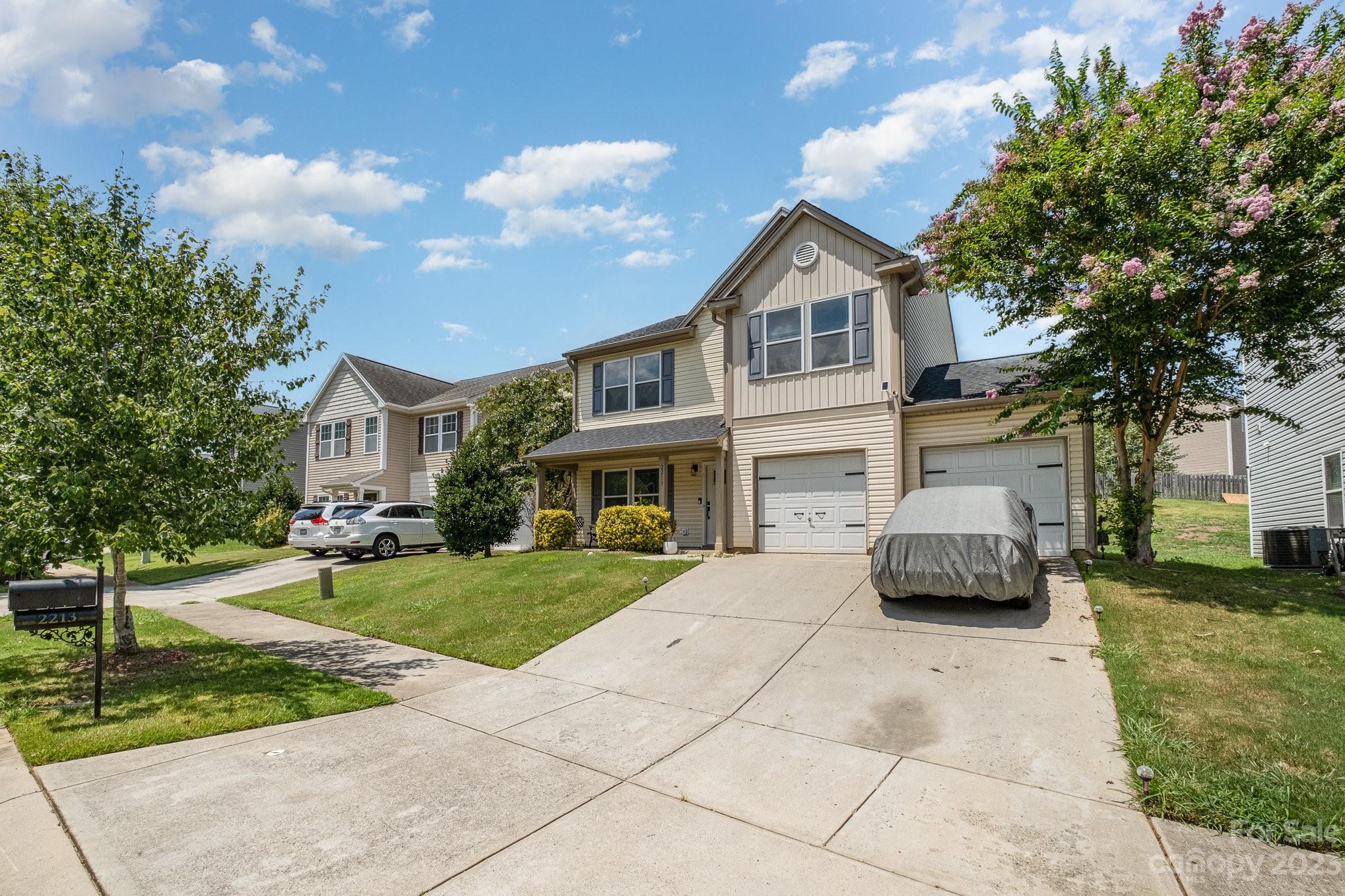 2213 Turtle Point Road Charlotte, NC 28262 - Photo 3 of 28 a front view of a house with a yard and garage