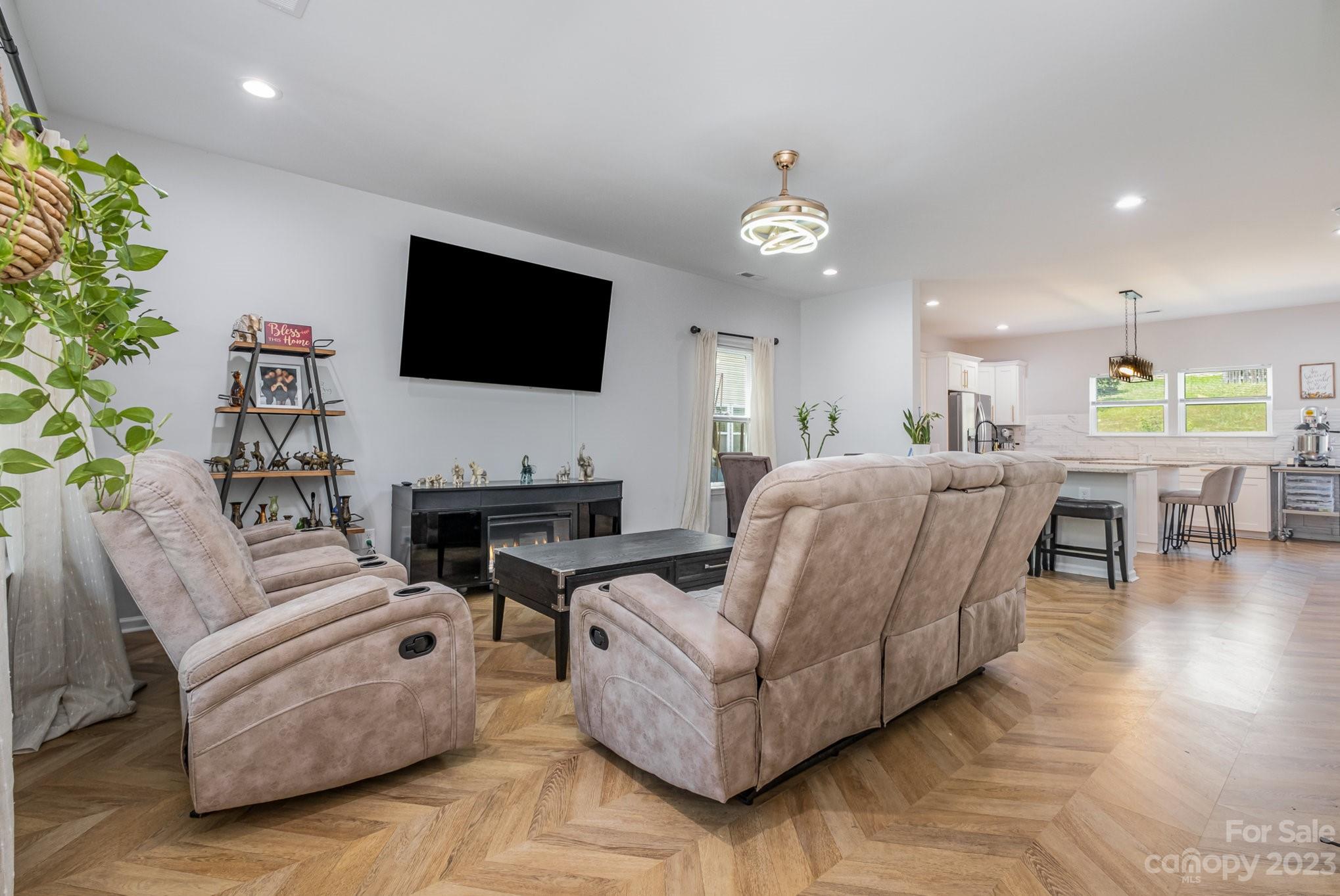2213 Turtle Point Road Charlotte, NC 28262 - Photo 5 of 28 a living room with furniture a fireplace and a flat screen tv