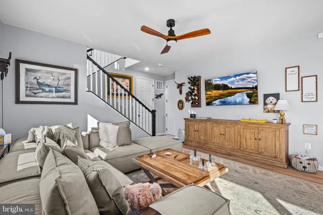 a balcony with chairs and a potted plant
