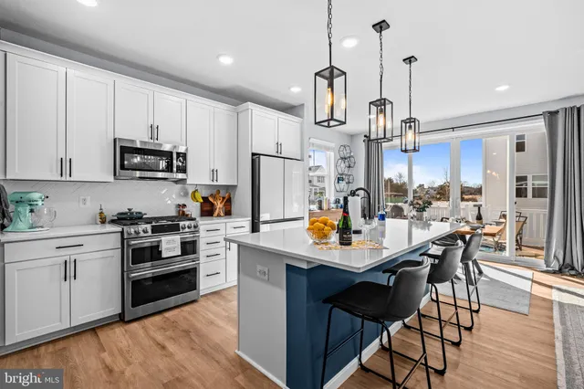 a kitchen with stainless steel appliances granite countertop a stove a microwave and cabinets