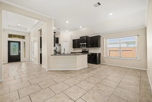a view of kitchen with microwave oven cabinets and refrigerator